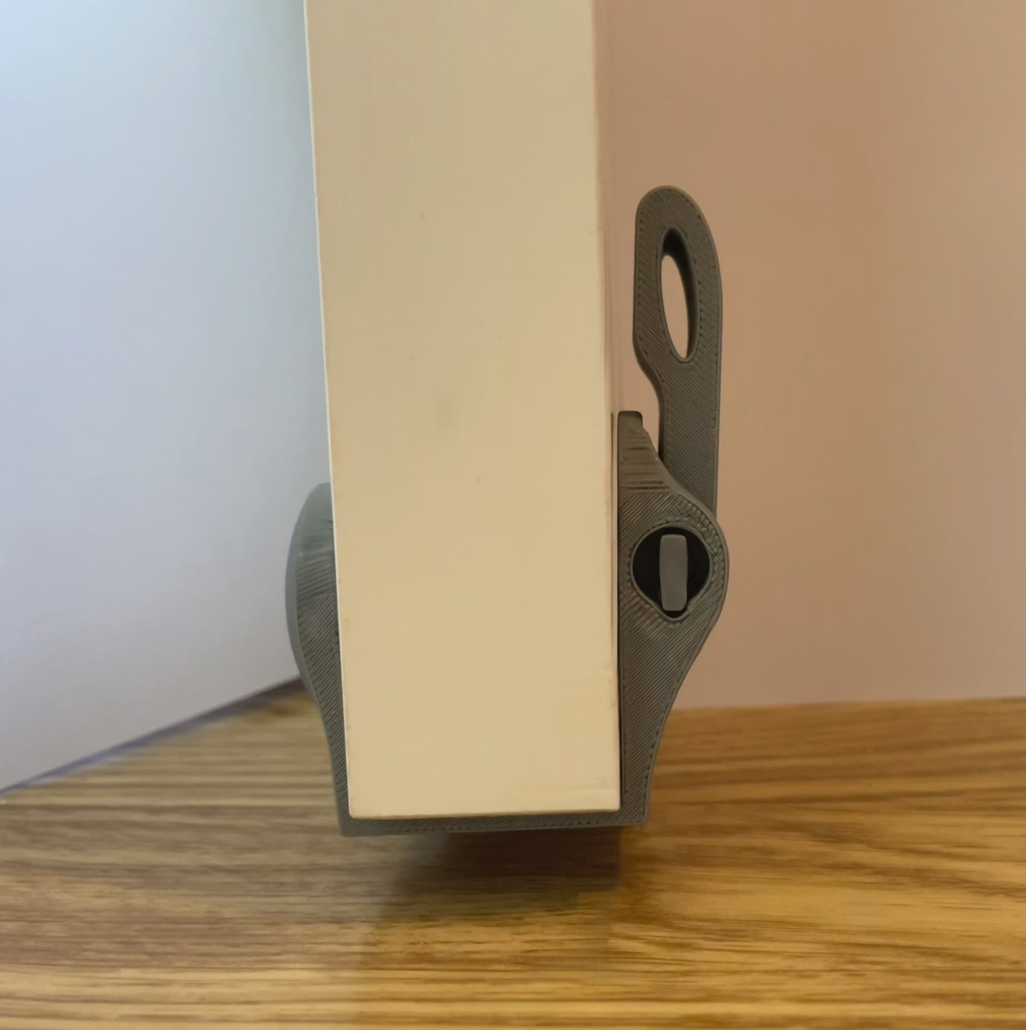HOLD prototype clamped on a door edge with the arm locked up